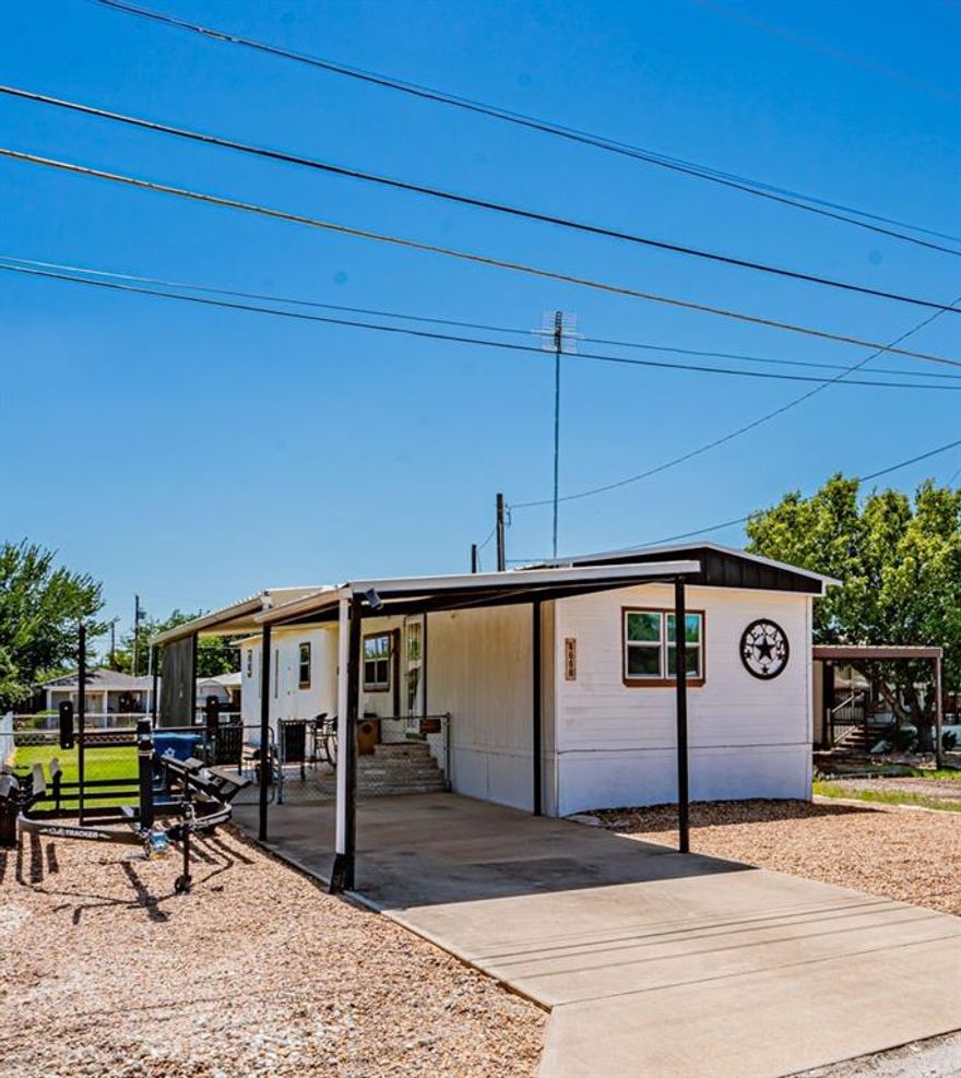 New Listing on the Lake! Get away for the weekend or great place to retire to. 2 bedroom, 2 full bath, recently updated, laminate floors, new windows, and more. Large outdoor living space for entertaining, or just relaxing by the lake. Newer covered dock with lift. Large concrete area, fenced yard, ready to enjoy. Partially furnished.