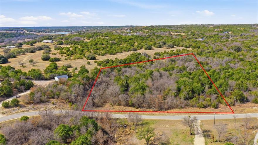 Discover your own slice of Texas paradise in Mountain Lakes Ranch in the charming town of Bluff Dale!  This scenic 3.52-acre tract offers the perfect blend of privacy, natural beauty, and breathtaking Hill Country views. Heavily treed with a mix of hardwoods and softwoods, native grasses, and a seasonal waterway winding through the property, this unimproved land is ready for your dream home, weekend retreat, or investment opportunity. Imagine morning coffee beneath mature trees, wildlife passing through, and wide-open skies at sunset.  Enjoy access to two private lakes, including a stunning approximately 45-acre fishing lake designed by legendary angler Jimmy Houston, plus a 100± acre recreational lake perfect for boating and water fun. Residents also have access to: Private lake boat ramps, Clubhouse, RV parking and storage, Campsites for guests, Community garden share, Exercise park and Play park.  All of this with low POA dues of just $295 per year, giving you access to amenities that truly set this community apart.  Whether you're looking to build now or buy and hold, this property offers peace, views, trees, and lifestyle all in one beautiful setting.  Come walk it, breathe it in, and picture your future here.