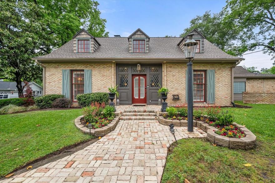 Built in 1931, this beautiful home is full of timeless character and charm. A classic brick walkway leads you to the front door, setting the stage for the unique details you’ll find throughout. Inside, the living room features a see-through fireplace that connects to a spacious eat-in kitchen complete with a large island and custom built-ins. The den also offers a cozy fireplace and built-ins, and is separated from the living room by elegant French doors. A stunning formal dining room with an abundance of windows provides the perfect setting for gatherings. The primary bedroom is located on the main floor and includes its own fireplace, a luxurious ensuite bath with built-in cabinetry, a large walk-in shower, and a walk-in closet. A second bedroom downstairs also features an ensuite bath, while upstairs, the third bedroom offers another fireplace and ensuite bathroom. An additional upstairs room can serve as a fourth bedroom, nursery, office, or playroom, and includes built-ins and a small loft area for added versatility. The home also includes a bright sunroom with beautiful brick flooring, perfect for relaxing year-round. Outside, the large backyard is a true retreat, featuring a brick-covered patio, winding brick and rock pathways, an outdoor fireplace, a gorgeous fountain, and an unattached garage. This one-of-a-kind property blends classic architecture with thoughtful updates, offering both comfort and style in every corner.