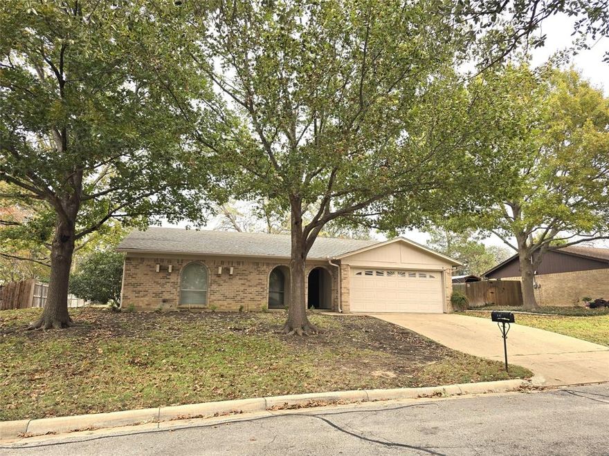Move-In Ready 3-Bedroom, 2-Bath, 2-Car Garage home in the Established Wedgwood Neighborhood! This charming property features a large, fenced backyard with mature trees providing added privacy, plus a storage building—perfect for lawn equipment or extra belongings. Inside, you’ll find a freshly painted interior in a lovely light gray highlighted by white trim and wood-look tile flooring throughout the main living areas, with brand-new carpet in all bedrooms. The spacious living room is warm and inviting, highlighted by a floor-to-ceiling brick fireplace and decorative wood ceiling beams, creating a perfect setting for cozy evenings at home. The well-appointed kitchen boasts stainless steel appliances and a large window over the sink that fills the space with natural light. An adjacent breakfast nook offers direct access to the covered patio, making it an excellent spot for morning coffee or relaxing after a long day. The primary bedroom includes a walk-in closet and a private ensuite bathroom. Secondary bedrooms are nicely sized and share a well-maintained full bathroom. Located in an established area of Fort Worth, this home offers easy access to major highways, local shopping, restaurants, and everything the city has to offer. A wonderful place to call home—schedule your tour today.