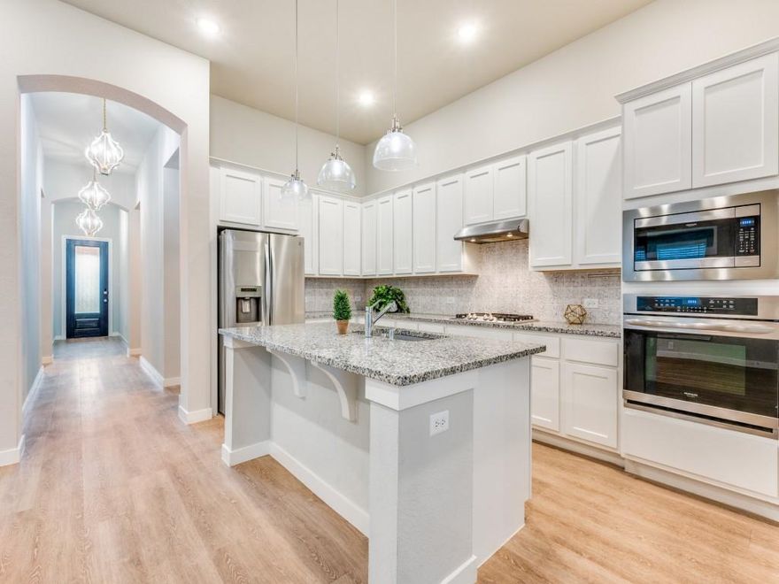 East-facing, Walking distance to the elementary school and effortlessly elegant, this sophisticated 4-bedroom, 3-bath home is nestled in the prestigious master-planned community of Sandbrock Ranch. Built in 2021, this designer-inspired residence offers an open-concept layout with high ceilings, abundant natural light, custom lighting, and refined finishes throughout.
Step onto stunning white pine luxury vinyl flooring that flows seamlessly through the main living areas—equal parts durable and beautiful. The kitchen is a true showstopper, featuring granite countertops, an oversized island, premium stainless steel appliances, custom lighting, and timeless white shaker-style cabinets. Seamlessly connected living and dining areas create the perfect setting for effortless entertaining.
The spacious primary suite offers a peaceful retreat, complete with a spa-like bath featuring dual vanities, a soaking tub, and a generously sized walk-in shower. Secondary bedrooms are thoughtfully designed, perfect for guests, kids, or a dedicated home office.
Step outside to your private backyard oasis featuring a covered patio, hot tub, and built-in fire pit—ideal for cozy evenings under the stars or lively weekend gatherings.
Sandbrock Ranch is more than a neighborhood—it’s a lifestyle. This master-planned community includes the Carriage House amenity center, a state-of-the-art fitness facility, an infinity-edge pool with splash pad, scenic trails, fully stocked fishing lakes, a dog park, and even a whimsical treehouse playground. With frequent community events and an on-site elementary school, it’s a place where neighbors become friends.