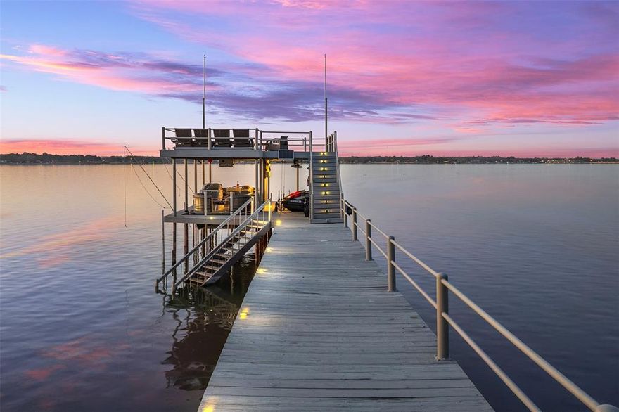 Waterfront Deep-Water Home on Cedar Creek Lake-Experience lakeside living in this recently remodeled home situated in a serene community, perfect for creating cherished memories. The open floor plan welcomes you with a stunning wall of windows that frame spectacular open-water and heated pool views. Spacious five-bedroom, three-full-bath residence offers room for everyone. The primary en-suite is located on the main level, boasting floor-to-ceiling windows overlooking the pool and lake with direct access. The additional main-level bedroom functions as a second primary with full bath access. Upstairs Retreat with three large bedrooms, including one with a golf simulator (impact screen, turf, projector), ample seating, and a terrace with panoramic water views. The beautifully remodeled chef’s kitchen features quartz countertops, custom cabinetry, a marble backsplash, an electric five-burner GE Profile cooktop, KitchenAid stainless appliances (including a side-by-side refrigerator with ice and water access from the door), double oven, dishwasher, and decorative lighting. The living area includes french doors leading to the outdoor patio and pool, as well as a doggie door for easy access to the exterior. A heated chlorine pool completes the outdoor space, surrounded by a fenced yard for privacy.  Enjoy an expanded patio with both covered and uncovered composite decking, a built-in outdoor kitchen featuring a Napoleon grill, sink, granite countertops, and custom cabinets. Multiple overhead electric heaters and a lakeside fire pit create the perfect environment for entertaining.  An extra-large  boat dock with composite upper deck is situated in over 8 feet of water at full pool and includes a cradle lift,, and a three-jet-ski lift. This exceptional home comfortably sleeps 16+ and offers strong investment potential. Don’t miss your chance to own this waterfront haven!