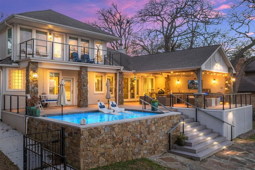 Waterfront Deep-Water Home on Cedar Creek Lake-Experience lakeside living in this recently remodeled home situated in a serene community, perfect for creating cherished memories. The open floor plan welcomes you with a stunning wall of windows that frame spectacular open-water and heated pool views. Spacious five-bedroom, three-full-bath residence offers room for everyone. The primary en-suite is located on the main level, boasting floor-to-ceiling windows overlooking the pool and lake with direct access. The additional main-level bedroom functions as a second primary with full bath access. Upstairs Retreat with three large bedrooms, including one with a golf simulator (impact screen, turf, projector), ample seating, and a terrace with panoramic water views. The beautifully remodeled chef’s kitchen features quartz countertops, custom cabinetry, a marble backsplash, an electric five-burner GE Profile cooktop, KitchenAid stainless appliances (including a side-by-side refrigerator with ice and water access from the door), double oven, dishwasher, and decorative lighting. The living area includes french doors leading to the outdoor patio and pool, as well as a doggie door for easy access to the exterior. A heated chlorine pool completes the outdoor space, surrounded by a fenced yard for privacy.  Enjoy an expanded patio with both covered and uncovered composite decking, a built-in outdoor kitchen featuring a Napoleon grill, sink, granite countertops, and custom cabinets. Multiple overhead electric heaters and a lakeside fire pit create the perfect environment for entertaining.  An extra-large  boat dock with composite upper deck is situated in over 8 feet of water at full pool and includes a cradle lift,, and a three-jet-ski lift. This exceptional home comfortably sleeps 16+ and offers strong investment potential. Don’t miss your chance to own this waterfront haven!