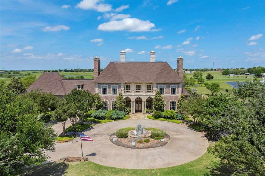 Experience all of the traditional and stately luxury that this estate has to offer! The aptly named Jardin du Soleil is rich with tasteful upgrades and finishes while surrounded by just over 4 and a half acres of peaceful Texas countryside. A gated entry and majestic circular driveway accentuated by a grand stone centerpiece greet you upon arrival, while a grand foyer sets the tone for the comfortable opulence that awaits inside the home. Keep warm by one of the 5 fireplaces peppered across the property, or cool off in the outdoor oasis which features a large covered patio, pool & hot tub with waterfall, and 2 additional outdoor living spaces. The oversized primary suite is located downstairs while all other bedrooms are upstairs, including a private suite with its own staircase to and from the 3 car garage. The kitchen is truly an entertainer's dream with dual ovens, an ice maker, Miele coffee system, wine fridge, dual sinks, 3 pantries, and a built-in refrigerator. Truly a must see!!