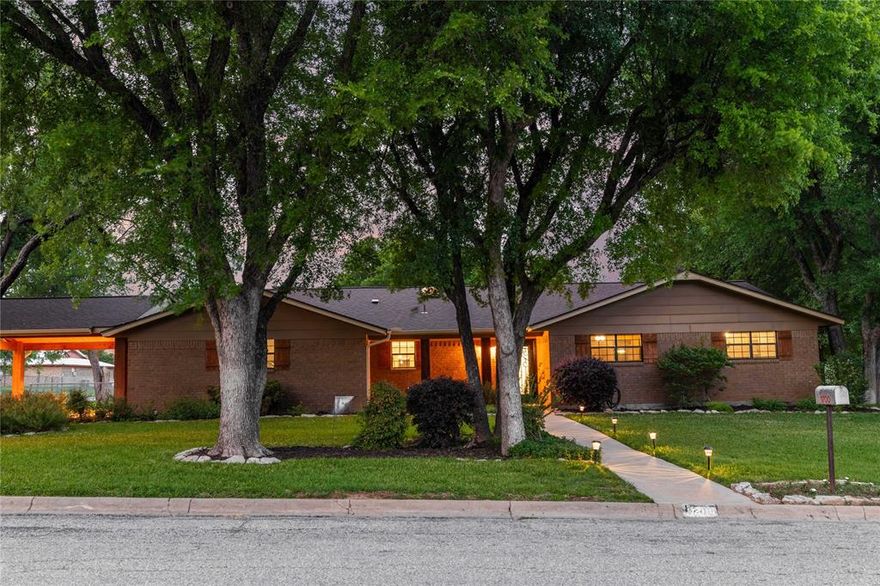 This stunning home sits on a spacious corner lot, shaded by beautiful, mature trees that create a warm and inviting feel the moment you arrive. With 3 bedrooms and 3 bathrooms, the layout is thoughtfully designed to offer a perfect blend of comfort, functionality, and charm.

Step inside to discover a light-filled interior with abundant natural lighting that enhances every space. The living room serves as the heart of the home, featuring a cozy fireplace and elegant crown molding that adds a touch of sophistication. Just off the primary suite, you’ll find a versatile den that can easily serve as a second living area, home office, or private retreat.

The kitchen is truly a standout, designed with both style and convenience in mind. It features a large island with electricity, a gas cooktop, a custom cross-tiled backsplash, double dishwashers, and pull-out cabinetry that maximizes storage and accessibility, perfect for everyday living or entertaining guests.

This property is equipped with a 2-car garage, an additional 2-car carport, and a separate shop complete with electricity and a garage door, offering ample space for parking, projects, or extra storage. Unique perimeter lighting runs throughout most of the home, adding both ambiance and functionality.

Step outside to enjoy the above-ground pool, ideal for cooling off during hot Texas summers or hosting gatherings with family and friends. With its thoughtful features, flexible spaces, and incredible curb appeal, this home truly has it all, comfort, character, and room to live, work, and play.