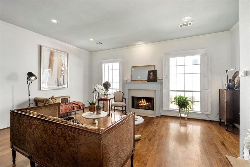 Nestled in the heart of Oak Lawn, this beautifully curated residence seamlessly blends timeless elegance with effortless urban living. Situated within a desirable four-residence enclave, the sophisticated three-story home evokes a subtle French Quarter influence with hints of Old New Orleans charm, offering a rare balance of privacy, style, and walkable convenience in one of Dallas’ most coveted neighborhoods.

Filled with natural light from expansive windows, the interiors feature rich hardwood flooring, custom shutters, refined finishes, and an airy, sophisticated aesthetic throughout. Thoughtful architectural details and the intimate courtyard setting create a warm, inviting ambiance. The first floor offers a versatile flex space ideal for a home office or creative retreat, complete with access to a charming private courtyard patio and attached two-car garage.

Designed for both elevated entertaining and comfortable everyday living, the second level showcases an open-concept living and dining area anchored by a cozy fireplace, alongside a bright kitchen and elegant powder bath.

Upstairs, both bedrooms feature private ensuite baths, including a serene primary suite with a spacious walk-in closet. A conveniently located utility room with full-size stackable washer and dryer completes the third level.

Perfectly positioned just moments from Whole Foods, the Katy Trail, Highland Park Village, Equinox, Downtown Dallas, and some of the city’s finest dining and entertainment destinations, this exceptional residence embodies classic sophistication, modern comfort, and timeless character in an unbeatable location.