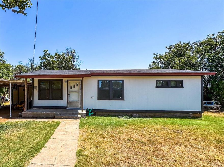 This charming remodeled two-bedroom, one-bathroom cottage in Rule is full of style and comfort. The exterior boasts new siding, fresh paint, and an oversized carport for plenty of covered parking. Inside, beautiful hardwood floors and a striking accent wall create a warm and inviting atmosphere. The updated kitchen is both functional and attractive, and the two spacious bedrooms provide ample private space. The full bathroom features rustic wood walls, adding a touch of character. Off the kitchen, you’ll find a full laundry area with room for an additional freezer. The large, shaded backyard is perfect for entertaining or relaxing, complete with an above-ground swimming pool for cooling off on warm Texas days.