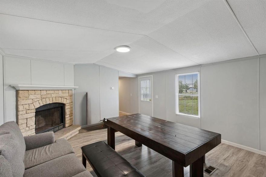 Updated property! This home features 3 bedrooms, 2 bathrooms, open kitchen and spacious living room. Enjoy the acreage around this property and a pond! Kitchen boasts room for a dining space and lots of cabinets. Living room is inviting with a fireplace and natural lighting. Main bedroom is split from secondary bedrooms and features an ensuite bath with a large garden tub, walk in closet, separate shower and amble countertop space. Secondary rooms all have new flooring like the rest of the home and share a full bath. Covered front porch is a perfect place to relax!