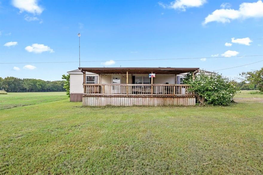 Welcome to this charming 3 bedroom, 2 bath doublewide mobile home situated on a peaceful 1 MOL acre with beautiful scenery. From the moment you arrive, you’ll appreciate the inviting huge covered front deck perfect for relaxing or entertaining. Out back, enjoy a covered back porch that can also serve as a sunroom, offering a cozy spot to unwind year-round.
This property also features a large workshop with high ceilings and electricity, ideal for projects, storage, or hobbies. Inside, the seller has recently painted the home’s interior and is in the process of updating the flooring, giving the home a fresh and welcoming feel.
Here you can experience the best of both worlds, peaceful country living with modern conveniences just minutes away.
A must see!  Call for your private showing today!