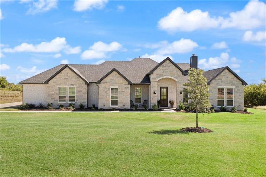 Built with the automobile enthusiast in mind, this property boasts an impressive 60x40 shop with a 40x30 enclosed build-out and a large lean-to perfect for RV parking, complete with electric and water hookups. The shop includes three 12' roll-up doors, a reinforced slab under the lift for added stability, LED lighting, two hardwired 220V plugs, and commercial-grade air compressor wiring — making it ideal for hobbyists or professionals alike.
Set on over an acre at the end of a cul-de-sac, this meticulously maintained single-story modern farmhouse offers an open-concept layout with designer touches throughout. Enjoy quartz countertops, luxury engineered hardwood flooring in main areas, and retractable screen doors at the front and back, allowing for fresh air and a breeze throughout the home. The spacious living area features a wood-burning fireplace with natural stone surround and rustic cedar mantle. A chef’s kitchen includes a large eat-in island, stylish custom cabinetry, and  stainless steel appliances — smart oven, cooktop, microwave, and dishwasher — perfect for entertaining.  The primary suite is a true retreat with generous space and a spa-like bath featuring a freestanding tub, rainfall walk-in shower, and a massive walk-in closet that flows directly into the oversized utility room for added convenience. Thoughtful design continues with 10’ ceilings and 8’ doors throughout, giving the home an elevated, airy feel. 
A rare combination of comfort, style, and high-functionality — this home is perfect for both everyday living and serious hobby use.