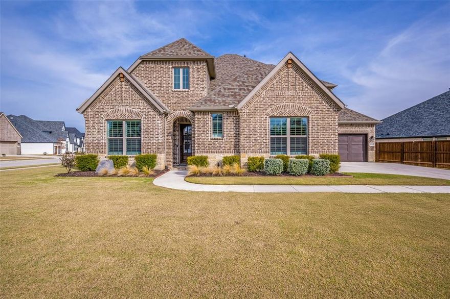 Check out this beautiful custom Drees Home on a corner-lot with NO PID or NO MUD fees. Zoned to top-rated Argyle ISD with Argyle South Elementary and Argyle HS located inside the neighborhood, as well as Liberty Christian private school within 5 miles. This 4-bed, 4-bath home offers an exceptional floorplan with soaring ceilings, updated wood-beam, designer lighting, and hardwood-style floors. The spacious living room filled with natural light boasts a stone fireplace and custom mantle and flows into a chef’s kitchen featuring a large island, stainless appliances, double oven, abundant cabinetry, and walk-in pantry. The primary suite offers a newly remodeled spa-style shower and dual vanities leading into a large master closet with the large laundry space conveniently located to bedrooms. Upstairs, enjoy a generous game room and private guest suite with plenty of flex space for entertainment, workout room, or more. Additional highlights include epoxy-coated 2-car garage plus additional separate 1-car garage, plus a covered patio overlooking a meticulously landscaped large yard. Enjoy HOA community events and social clubs, included internet and tv, front yard maintenance, along with amenities including resort-style pool, fitness center, clubhouse, nature and paved walking trails, dog park, catch-and-release fishing pond, water features, and extensive preserved open space (200 acres) weaving through the community—all with quick access to FM 1171, US 377 & major highways for easy commutes to DFW airports, schools, dining & entertainment.