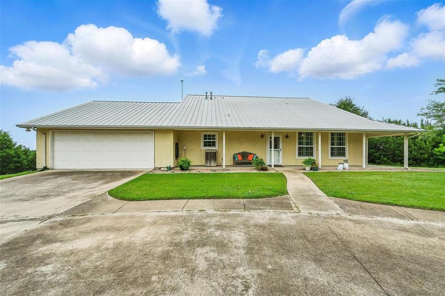 PRICE REDUCTION TO SELL. Hidden hilltop gem in Bentwater Subdivision. Follow the private drive up to this stunning retreat offering breathtaking views and privacy. A circular driveway welcomes you to a detached 32x24 garage complete with electric, water, sewer, and an RV pad with hookups, perfect for guests or extra storage. An oversized attached garage easily accommodates 2 full-sized trucks. Inside, enjoy a spacious kitchen with a large center island, abundant storage, double ovens, stainless steel appliances, and a gas line ready for conversion to a gas cooktop. The home features beautiful, engineered hardwood floors, plantation shutters, and a unique circular layout that maximizes the incredible lake views from the primary suite, secondary bedrooms, kitchen, and living area. This home is wheelchair accessible. The primary bath includes heated floors for year around comfort. This home conveys with an assigned boat slip C-22 at the Marina, where you will also find a clubhouse, picnic area & sport court for homeowners use.  A truly rare find, peaceful and practical.  It's an easy hop to Downtown Granbury for great dining and live entertainment venues and less than 45 minutes to the DFW Metroplex. Its on the Fort Worth side of Granbury.