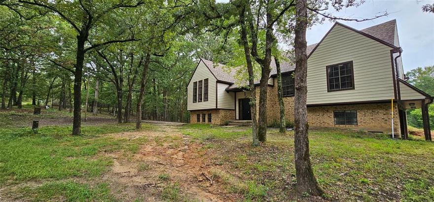 Secluded Retreat on Nearly 9 Acres. If peace and privacy are what you’re looking for, welcome home! This newly renovated property offers nearly 9 acres of land—partially cleared around the home for convenience while still surrounded by beautiful trees and natural seclusion. Step inside and you’ll be greeted with a perfect blend of rustic charm and modern flair. From the front landing, head down a short flight of stairs to a cozy living area featuring a brick fireplace, bedroom, full bath, and a spacious laundry room. With direct access to the oversized 2-car garage and plenty of storage, this level is ideal as a primary retreat, guest suite, or private in-law space. Go upstairs from the landing to the heart of the home. The main living area boasts a large living room with another brick fireplace, an inviting dining area, and an eat-in kitchen. Step outside onto the expansive covered back patio—complete with your own hot tub—perfect for entertaining or simply relaxing while enjoying the surrounding views. Down the hallway, you’ll find a full bath, two additional bedrooms, and a generous primary suite. Every window showcases gorgeous scenery, with wildlife all around to remind you just how special this setting is. At the end of the drive there is a large storage building.  All this privacy, yet only minutes from downtown Winnsboro where you’ll find local dining, shopping, and the charm of strolling around the square.