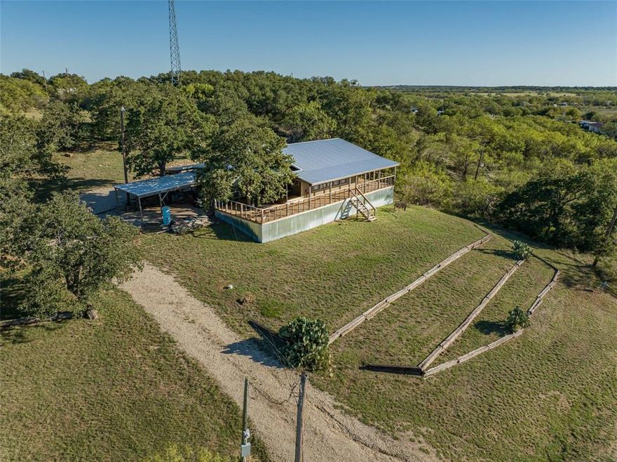 Enjoy breathtaking sunset views of Hubbard Creek Lake from 2.66 acres on one of the highest summits in Stephens County, just 2 hours west of the Metroplex and only about 40 minutes from Abilene’s Lancium Data Center. This unique 3 bed, 2 bath lakeview cabin features an encapsulated manufactured home with a large front room addition filled with windows overlooking the lake. A separate bedroom with private bath and laundry offers added privacy. The 1,000 SF wraparound deck creates the perfect setting to enjoy the scenery. The property comprises 6 lots with strong investment potential, ideal for Airbnb or future subdivision. The upper summit offers 3 road-front lots with a cleared build site and gated entrance to FM 223, perfect for building a new home while using the cabin during construction, then renting it later. The lower level includes 3 additional lots with a separate entrance. Deep water well, seller unsure of current functionality, utility pole security light, and new metal roof in 2022.