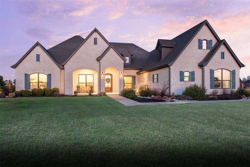 If you like a home full of character and upgrades, you will love this one in LOVEJOY ISD!!  From the stone walls to vaulted ceilings to custom cabinetry and built ins, there isn't a room that isn't special.  Hardwood floors flow through the house with an open layout and walls of windows overlooking the well manicured and landscaped yard.  The kitchen features high end appliances that include a Bosch dishwasher, Blanco Sil Granite apron front sink, European style gas range with three ovens and a 5 burner cooktop and pot filler. The entire house features custom designer lighting and automatic window shades and built in speakers. The primary bedroom features a brick facade accent wall while each of the secondary bedrooms also feature custom wall treatments and walk in closets.  The laundry room didn't get overlooked either! With a copper apron front sink and brick look tile flooring, the laundry room also has a built in drop zone with hooks and cubbies, built in drying racks and cabinetry as well as a refrigerator hookup. Outside, you'll find an oversized covered patio, heated diving pool with water features and built in infinity edge spa, custom turf decking, built in outdoor kitchen, putting green and golf chipping, fenced enclosure for pool equipment, in ground basketball goal at the driveway. The four car garage features stairs to a walk in attic storage room, a steel tornado shelter, under stair storage room and a generator transfer switch.