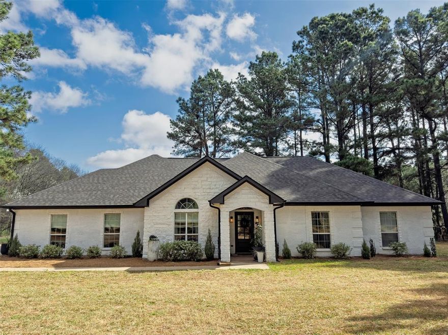 Custom built home on 3 private, tree lined acres with no city taxes. Located just over 1 mile from downtown and within the loop, the property is also within walking distance to Cain Park and the YMCA. 

Surrounded by mature pine trees with scenic pond access, it has a peaceful setting while remaining close to town.

The home features 4 bedrooms with walk in closets, 2 baths and 2 car garage with storage. Hardwood flooring in the main living areas, granite countertops, custom stained wood cabinetry, upgraded stainless steel appliances, and 2 dining areas. The spacious primary suite includes an ensuite bath, large closet with built ins with direct access to the laundry room.

Additional features include a Class III impact resistant roof and gutters replaced Winter 2024, shared private water well, gated yard for pets and storage building with electricity.