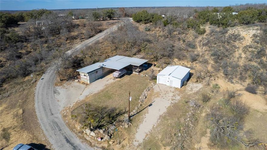 This is an amazing opportunity to own an affordable lake house!   The home is a quarter mile from the boat dock & next door to the community pool!  Pontoon boat, golf cart, riding mower, 2 grills & a smoker, as well as all furnishings are included, making this a turnkey, move in ready lake house!  The entire home, as well as a the beautiful 37x25 patio are covered, plus 2 oversized covered parking spaces.  In the last few years, it has had fresh paint, new: subfloor, luxury vinyl plank flooring, refrigerator & electric cooktop, plus the HVAC system is only a year old & was just serviced.  The open floor plan really opens up the space & the living room sectional is new.  The large covered patio is perfect for grilling & entertaining & even has a sink and food prep area.  Also included is a very nice 40x28 metal shop with a 10 foot roll up door so that you can store your boat or small RV.   It was set up for welding as well and has multiple plugs plus 220V available.  10x50 dog run.