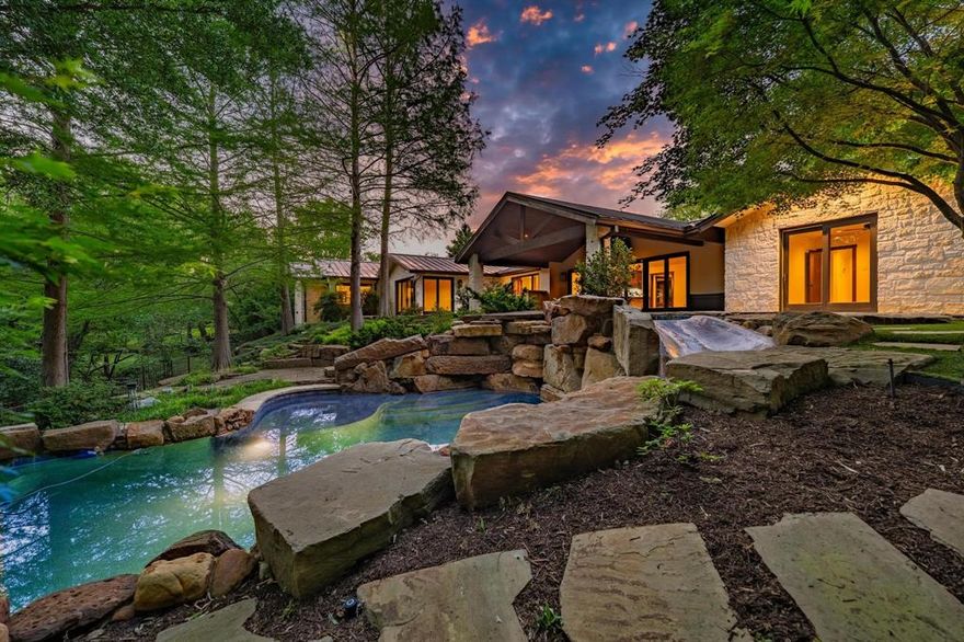 Step into this 1 story oasis minutes from White Rock Lake and downtown Dallas.  Enjoy the beautiful and tranquil professionally landscaped .5 acre creek lot.  You will love this light & bright soft contemporary with Hill Country flair.  Open floorplan features wall of windows to creek and large covered patio.  Kitchen features Wolf & Sub Zero appliance package.  Spacious primary suite enjoys expansive views of outdoor retreat and features huge walk in closet and a spa like bath with dual vanities, large soaking tub and large walk in steam shower.  The large game room features second fireplace and wall of built in's.  Large secondary bedrooms allow for many possibilities.  Backyard retreat features resort style 2 level pool with spa and slide along with outdoor kitchen and fire pit.  Don't miss this special home!