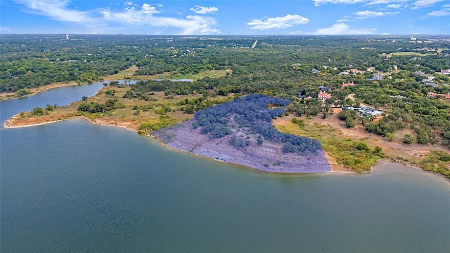 Rare 3.68-acre lakefront homesite on Grapevine Lake! Positioned on a serene cul-de-sac within the prestigious gated enclave of The Landing, this extraordinary property is one of the only peninsula lots on the entire lake offering over 1,200 feet of pristine shoreline, a private beach, and the rare privilege of being surrounded by 120 acres of protected Corp property. A truly once-in-a-lifetime opportunity, this lot boasts breathtaking panoramic water views from nearly every angle and provides the ultimate setting to build your custom luxury estate. Imagine enjoying spectacular sunsets from your backyard oasis or future balcony, with nature and the lake as your permanent backdrop. The Landing offers the perfect blend of privacy and accessibility. Just 20 minutes from DFW Airport, major highways, acclaimed schools, and Liberty Christian Academy, this exclusive community makes seclusion and convenience a reality. Opportunities of this caliber are virtually impossible to find. Lakefront acreage of this size, prestige, and uniqueness simply cannot be replicated. Claim your piece of Grapevine Lake and create the luxury estate you’ve always envisioned! Last 8 photos of listing are conceptual renderings to give an example of what can be built on this fabulous property.