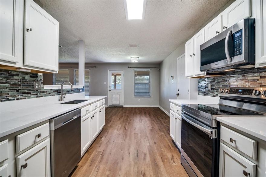 This spacious 3 bedroom house with 2 living areas and a dedicated office is ready for you to call it home! Located near the end of a cul de sac, the kitchen and bathrooms have been recently updated. The large primary bedroom has an ensuite bath with dual sinks, a deep soaking tub and separate shower. Sip hot chocolate while you sit by the fireplace on those chilly nights. The secondary living area can be used as a flex space, playroom or dining area. A large covered patio spans the back of the house and is the perfect place to relax. Refrigerator, washer and dryer are included.