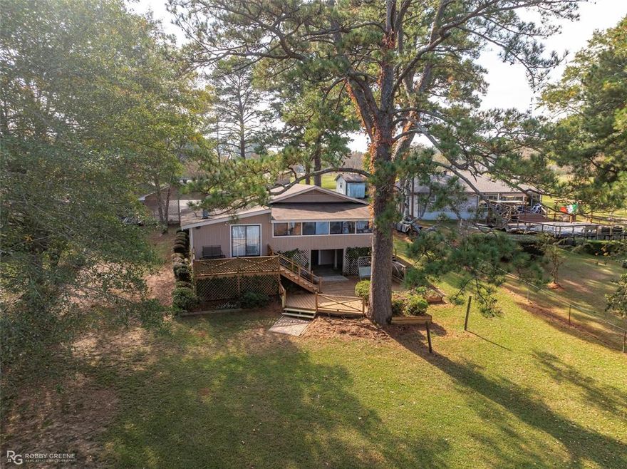 Price Enhancement!! Experience true waterfront living on one of Louisiana’s premier recreational lakes with this well appointed 4-bedroom, 2.5-bath Lake Claiborne home. Perfect for fishing, swimming, skiing, kayaking, and year-round enjoyment, this property offers an incredible blend of relaxation and adventure. Lake Claiborne is well-known for its exceptional fishing—stocked with largemouth bass, bluegill, crappie, and catfish—and also features sandy beach areas, hiking and nature trails, birdwatching, and bike paths for outdoor enthusiasts.

Designed to maximize lakeside living, the home features an open-concept layout that seamlessly connects the living, dining, kitchen, and sunroom—each offering spectacular waterfront views. Outdoor amenities include a massive two-stall boathouse with a covered sitting area, an additional pier ideal for sunbathing, and a multi-level deck perfect for entertaining. A concrete seawall provides added stability, and the fenced yard offers privacy and secure space for pets or children. Additional conveniences include a spacious basement for storage, a two-car carport, an HVAC unit approximately five years old, and a roof installed around seven years ago.

Located on the desirable southeast side of Lake Claiborne, this property is ideal as a full-time residence, weekend getaway, or high-demand Airbnb investment. Don’t miss the opportunity to own a true waterfront retreat, great for entertaining, relaxing or lake life living —schedule your private showing today.