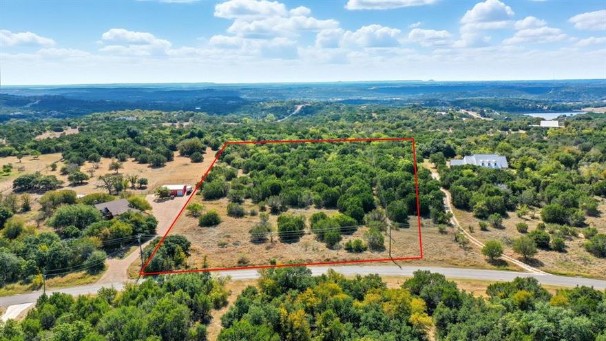 Build your dream home on this panoramic 5 acre lot featuring native grass and scattered mature trees. This property offers an ideal canvas to bring your vision to life and to enjoy the tranquility of country living with ample elbow room. Hard to come by, highly usable land with lots of character. Water & electricity are available at the street. Mountain Lakes Ranch offers two private lakes, community pool, club house, RV Park, and storage along with an exercise & play park. Bluff Dale, TX is located about one hour west of Fort Worth and convenient to Glen Rose, Stephenville, Granbury and Weatherford.
