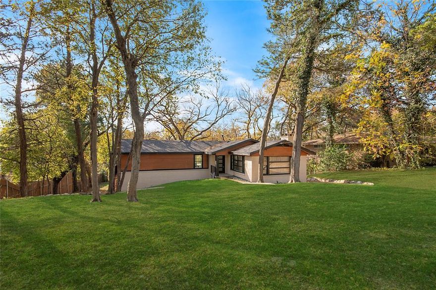 A true original, one of one. This reimagined handcrafted residence situated on a scenic lot, over an acre, is a seamless blend of Mid century within its surrounding nature. Nestled down its driveway tucked behind its soaring trees and surrounded by its lush landscape - a tranquil retreat within the city awaits you. As you wander down the gravel path, the abundant landscape draws you closer, as the transformation begins. As you step through the heavy iron door you are instantly welcomed by views to the scenic outdoors. Introduced to the functionality of the open floorplan, the living room is illuminated by natural light streaming through an abundance of windows and vaulted ceilings. Sliding doors open to the oversized deck overlooking the endless expansive yard and bountiful supply of mature trees. The beautiful kitchen serves as the heart of the home with large island, SS appliances, exit door to the outdoors & designer sink w portrait window. Every space throughout the home filled with windows that frame views and allow the indoors and outdoors to live in harmony. The primary bedroom is a true retreat, brick fireplace, wall to wall windows, and ensuite bath. The top floor offers an additional full bath, a second bedroom w door providing direct access to the outdoors, and a third bedroom complimented w large portrait window offering gorgeous views. As you make your way to the bottom level, you are embraced with a large second living room w access to the outdoors and accompanied by two additional spacious bedrooms and full bath. The vast backyard oasis provides limitless opportunities, tucked away, this property is more than a home. It’s a sanctuary. A place apart. Everything brand new and all the room you need to truly make this home yours, don't miss this rare opportunity!