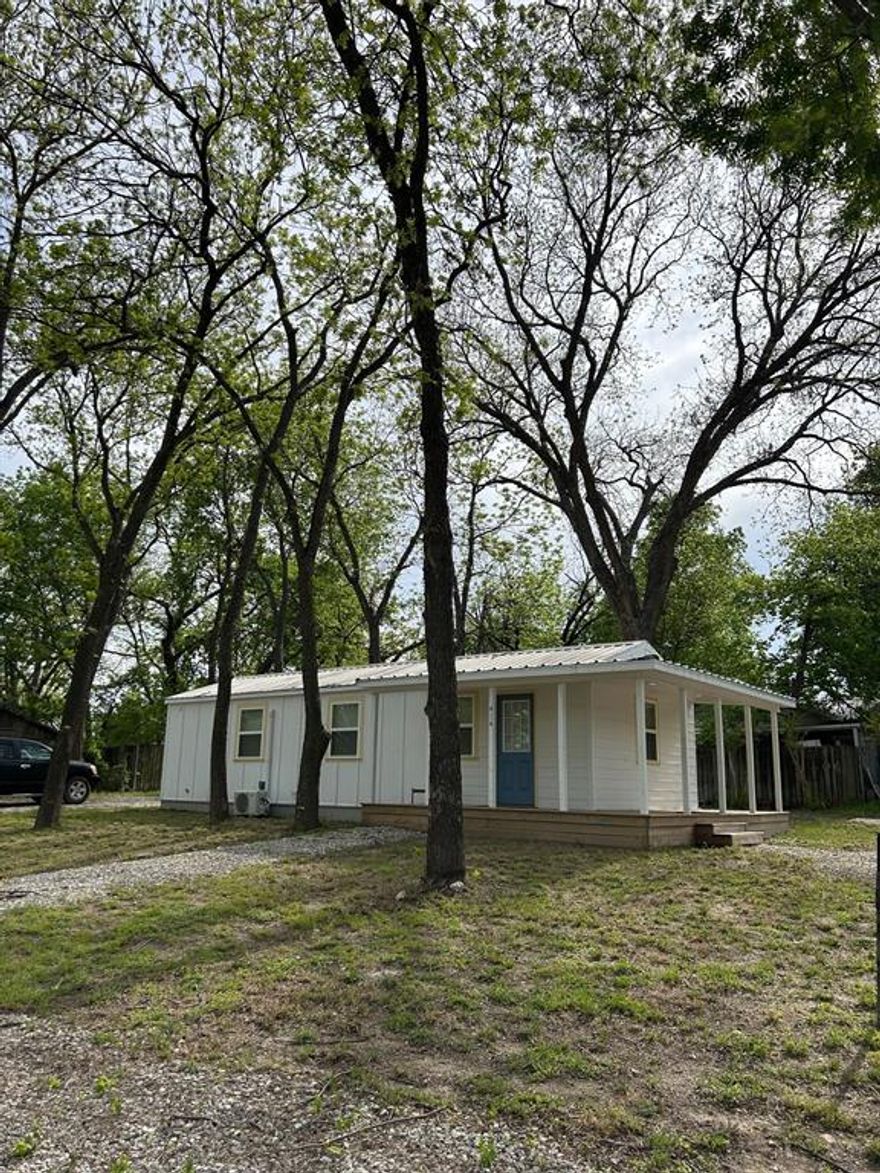 Remarkable multipurpose property on large corner heavily treed lot!  Great investment property with unlimited possibilities  for business, office, or tiny home one block away from Hwy 6.  Ample parking spaces on 3 sides of structure with 6 to 8 inch rock base.  With a zero build line on lot, there are multiple options for expansion on south and west sides.  Building is one year old and energy efficient with all LED lighting, fans, low E double pane windows, luxury vinyl plank flooring, stackable washer and dryer, dishwasher, on demand water heater, fiberoptic wiring and internet ready, smart siding (super durable and doesn't crack as easily as Hardy board), metal roof, split AC unit with 200 Amp underground electrical service.  Existing 6x8 storage unit stays!
Every sf of the 600 sf building is maximized with large open area on one end and bathroom and kitchenette on other end.  The large open area could serve as an office or could easily be divided into a bedroom and living area for a beautiful and efficient tiny home!  Also plenty of room on lot to add carport, shop, greenhouse or other structure.  Exceptionally attractive building with minimal maintenance and a great wrap around porch on 2 sides, surrounded by 15 plus mature pecan trees provides peace and relaxation!