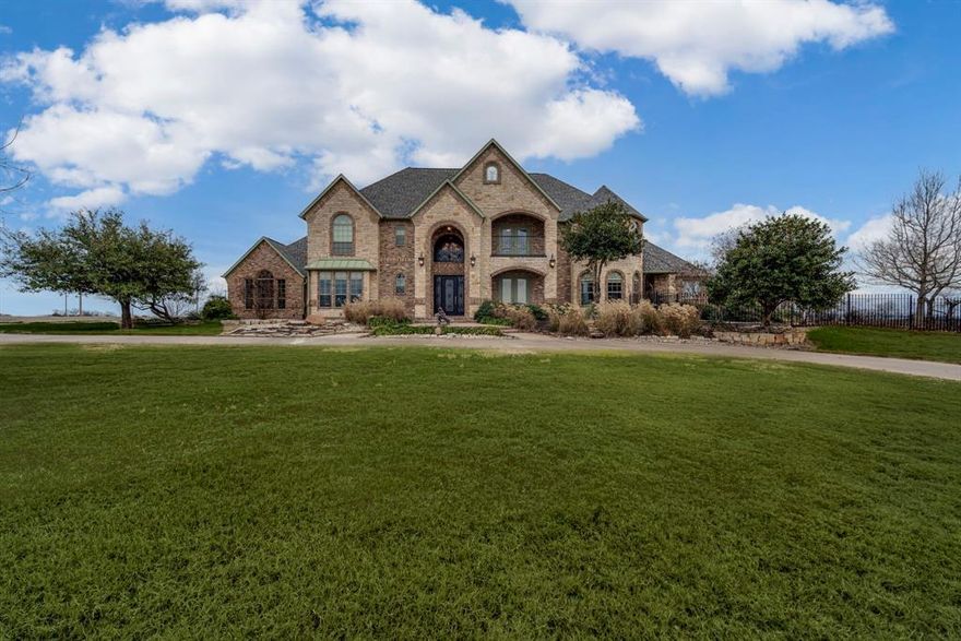 Seller offering 10K in concessions to use how you like! Multigenerational home nestled in the serene and sought-after Crystal Cove community, this one-owner custom-built masterpiece offers unparalleled elegance and breathtaking views of Lake Waxahachie. Situated on over six acres of picturesque countryside, this estate combines the tranquility of nature with the sophistication of modern design. From the moment you step inside, the exquisite finishes and attention to detail are evident, showcasing a perfect balance of comfort and grandeur. Designed for both entertainment and relaxation, this expansive home boasts multiple living areas, a formal dining room, and an open-concept kitchen and living area, all bathed in natural light. The luxurious main-floor master suite features a spa-like retreat with dual vanities, a body-spray shower, jetted tub, and a custom closet with a beautiful designated vanity space. Upstairs, four additional bedrooms and multiple balconies offer sweeping panoramic views of the lake, creating a haven for family and guests alike. Additional highlights include a game room, an elevator, energy-efficient construction, abundant storage and an unfinished attic space that would make an amazing man cave. The exterior is equally impressive, with meticulously maintained grounds and ample space for outdoor gatherings. With three HVAC units ensuring year-round comfort, this home epitomizes executive-style living at its finest. Whether you’re enjoying a quiet sunset on the balcony or entertaining in style, this Crystal Cove gem offers a lifestyle of unparalleled luxury and refinement. Don’t miss the opportunity to make this stunning estate your forever home.