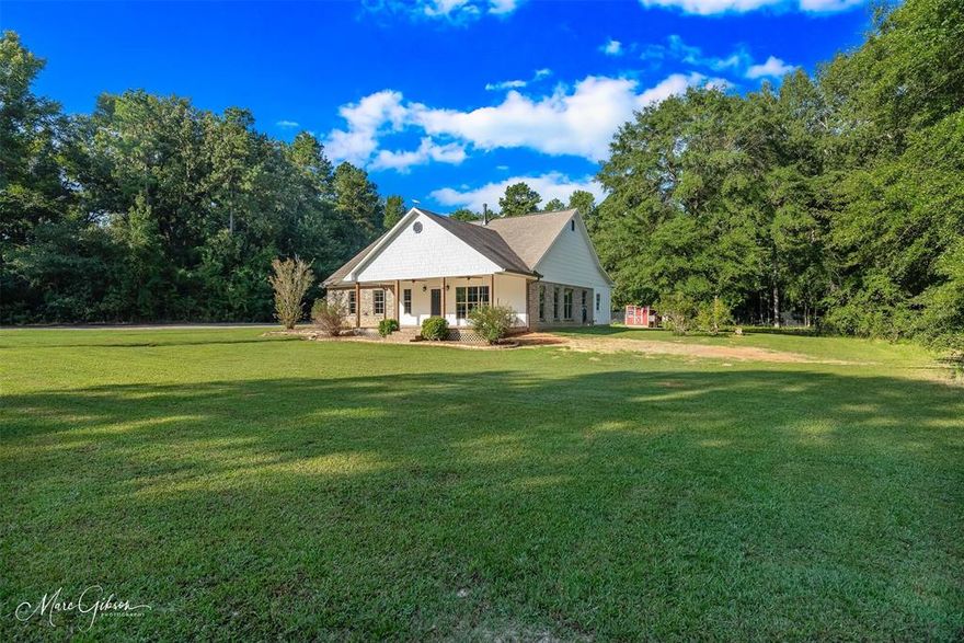 Escape the hustle and bustle to your very own slice of country comfort in this custom built modern farmhouse on 5 acres! As you pull into the driveway, you'll love the privacy of the home being set back off the road. The front porch swing will be calling your name to come and stay awhile with a book and a glass of sweet tea. Inside, the heart of the home is wide open—kitchen, dining, and living flow together seamlessly so you’re never far from the conversation. The large kitchen island with butcher block countertops and the Thor commercial gas range are a chef's delight and will have you itching to host game nights or Sunday suppers! And the oversized pantry has ample storage for dry goods and those small appliances you don't want cluttering your counters, as well as room for a full-size standup freezer (to house your secret Blue Bell stash, of course). A wood burning stove adds to the warmth and charm of the living area!

From the garage entry, you'll be wowed by the mudroom and coffee station or wet bar with butcher block counters. Need space for hobbies or work? You’ll find a dedicated office plus a storage room that can double as a second pantry. There’s even a secure gun armory tucked in just right. The primary bedroom is situated separate from the secondary bedrooms with a newly updated bathroom for a luxury feel. A large laundry room connects to the primary suite to cut down the hassle of laundry. The secondary bedrooms are also very spacious, with a bathroom that has both a tub and shower. 

Outdoors, the land is already partially fenced for livestock, and the chickens even come with the home! A 24x30 workshop stands ready for projects, tinkering, or storing all your toys and tools. 

With a front porch perfect for sweet tea sipping, a shop out back, and plenty of space to spread out, this place blends modern comfort with a good dose of down-home living.