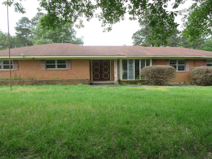 Large home with 3 bedrooms and 2 full bathrooms. Large living room with wood burning fireplace. Nice size kitchen with kitchen dining area and separate dining room area. Large den. Good size bedrooms.  Big 1 acre lot with extra-large storage area for your boat, equipment. Lot is fenced with gate. AGENTS: see agent remarks on how to submit an offer.