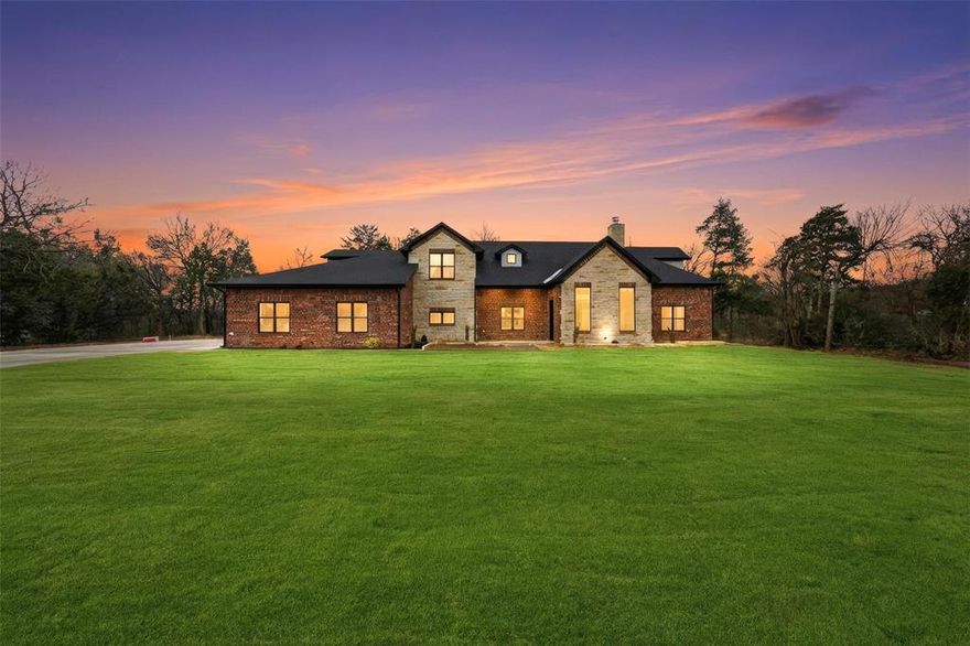 Located in a quiet cul-de-sac on just over 2 acres, this spacious 5-bedroom, 4.5-bath home offers privacy, generous space, and a well-designed setting. The property features a long concrete driveway, providing a welcoming approach and ample parking, along with open acreage that enhances both privacy and usability. Inside, the home showcases hardwood flooring, high ceilings, and a bright, open layout designed for comfortable everyday living. The main living area features a fireplace, creating a warm and inviting focal point. The kitchen is thoughtfully designed for both function and entertaining, featuring Quartzite countertops throughout, handmade inset Shaker cabinetry, a large center island, double ovens, stainless steel appliances, and custom tile finishes. A built-in mud area and spacious utility room add convenience and practical organization. The primary suite offers a private retreat with dual vanities, a soaking tub, an expansive walk-in closet, and a luxurious custom shower with dual shower heads. Secondary bedrooms are generously sized and provide flexibility for a variety of needs. The second level includes additional living space and a private balcony patio overlooking the surrounding acreage, offering elevated views and a quiet outdoor escape. The backyard is designed for enjoyment and entertaining, featuring a stamped concrete patio with an outdoor grill, ideal for gatherings and relaxation. The home is also pre-wired for a speaker system, adding modern convenience. A rare opportunity to enjoy spacious country-style living with modern comfort and functional design. Buyer and buyer’s agent to verify all information, including measurements, schools, and features.