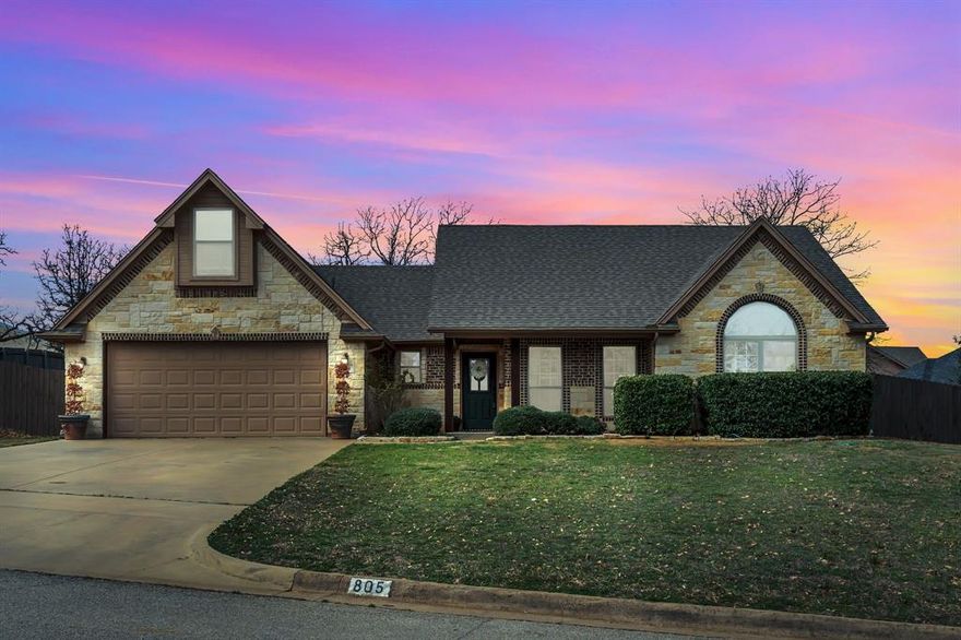 Welcome to this beautifully crafted rock and brick home, ideally situated on over half an acre in a quiet, established Joshua neighborhood. Offering 1,932 square feet of thoughtfully designed living space, this 3-bedroom, 2-bath residence features an open-concept layout with soaring ceilings and a striking floor-to-ceiling stone fireplace that creates a warm and inviting focal point. The spacious kitchen offers abundant cabinetry, ample counter space, bar seating, and a charming bay window dining area overlooking the backyard and pool, making it ideal for both everyday living and entertaining.

The private primary suite is tucked away for comfort and privacy and includes dual vanities, a soaking tub, separate shower, and generous storage. Secondary bedrooms are well-sized with great natural light. A large upstairs bonus room provides exceptional flexibility and can serve as a second living area, game room, guest suite, or home office.

Step outside to your own backyard retreat featuring a resort-style pool, elevated spa, and expansive patio space perfect for outdoor dining, relaxing, or hosting gatherings. The oversized lot offers rare additional space with potential for future building!

This exceptional property offers timeless curb appeal, functional design, and outstanding outdoor living, all within a peaceful neighborhood setting with room to grow.