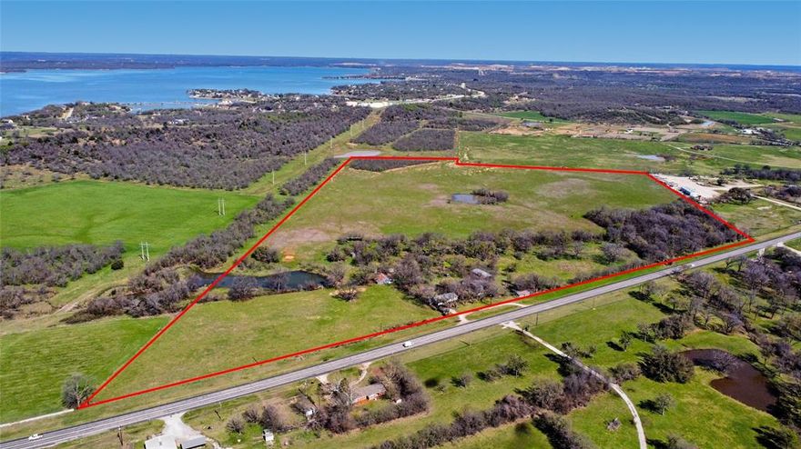 Discover the perfect blend of privacy, natural beauty, and accessibility with this stunning 72.67-acre property located just minutes from Lake Bridgeport. With over 2,000 feet of Highway 380 frontage, this property offers excellent access and outstanding potential for agricultural use, recreation, or future development. The land features rolling hills, open pastures, and mature trees, creating a picturesque North Texas landscape. Established pecan trees add both character and potential productivity to the property. Extensive cross fencing makes it well-suited for livestock, grazing, or a variety of agricultural pursuits. The property also includes a small farmhouse and several outbuildings, offering flexibility for storage, ranch operations, or future improvements. Whether you’re looking to build your dream ranch, expand an agricultural operation, or invest in a highly desirable location near Lake Bridgeport, this property offers endless possibilities. Opportunities like this—large acreage with highway frontage in a rapidly growing area are increasingly rare. Information deemed reliable but not guaranteed. Please confirm all details.