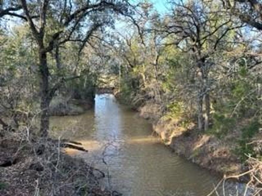 This 575 +- acres offers diversity and character throughout the ranch.  Everything anyone is looking for can be found here…..elevation, beautiful views, oaks, heavy cover, lots of wildlife, creek draw, rock outcroppings, & food plot areas.  Plenty of deer, turkey, dove, hogs, & varmints & the cover is ideal for the wildlife to thrive.  Several surface tanks provide water for the wildlife and provide opportunities for a relaxing afternoon fishing..4 stocked with fish.  Hay Creek winds throughout the ranch with large trees up and down the banks that the turkey love to roost in.  There are numerous vantage points on the ranch with views across the country side.

There is a new 3,2 doublewide sitting on one hillside with large mature oaks.  The home has carpet and vinyl flooring, a split bedroom arrangement, open concept living,dining,kitchen area, and covered porches.  A two car carport and storage building complete the amenities.

Minerals will convey with acceptable offer.