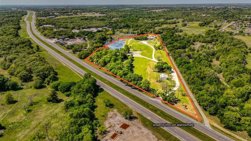 Premier Event Venue and Development Opportunity on US Highway 180.
Spanning 15.92 acres along the highly trafficked US Highway 180 (Mineral Wells Hwy), this exceptional property boasts over 1,100 feet of valuable Highway 180 frontage and is located just 4 miles from historic downtown Weatherford, Texas.

This versatile property has long served Parker County as a popular event center, conference center and wedding venue. It includes three primary buildings, a historic log cabin, and beautifully wooded acreage with several trails and garden areas.
 Main Building
The two-story main building features:
3264 sqf total
two restrooms
 Dressing rooms
 Bar and kitchen area
Upstairs event space: 600 sf, seating for 50 guests
 Main floor: covers over 2600 sf and seating for 120 guests
 Pavilion
The second building is a spacious pavilion, ideal for smaller gatherings, with:
2007 sf of covered space, two restrooms and a kitchen and will seat 125 indoors and 250 outdoors.

Located at the entrance of the property is an office featuring:
1200 sf of space and one full bath
 Additional Features
A charming historic settler’s log cabin located beside the main venue, offering potential as a short-term rental with minimal renovation
 Numerous mature trees, gardens and scenic trails across the front of the property along with a small lake, private water well and 3 septic systems.
Behind the main event building is a lighted outdoor entertainment area that includes a stage, dance floor and covered seating.
 Investment Potential
This property offers exceptional potential for future development, such as an RV park, Industrial Park or can continue as a turnkey event center.
Don't miss this rare opportunity to own a prominent piece of Parker County real estate with endless possibilities.
Buyer and Buyers agent should confirm all information is accurate.