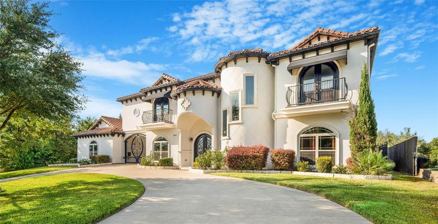 Step into timeless sophistication with this stunning 5-bedroom, 4-bath Spanish-style estate, where classic design meets everyday functionality. From the moment you arrive, the turret staircase and graceful port cochere set the tone for a home that’s both dramatic and inviting.
Inside, arched windows and wrought iron accents frame sunlit living spaces, while the layout offers room to gather, retreat, and entertain with ease. The spacious kitchen and living areas offer easy access to the large, paved deck leading to the backyard, perfect for hosting. While the private bedrooms, including a luxurious primary suite with an attached 14x14 custom closet, offer comfort and privacy for all. Imagine yourself enjoying the morning breeze on your upstairs balcony which offers stunning and relaxing views of Joe Pool Lake. 
Outside, the circular driveway welcomes guests in style, and the extra rear parking ensures convenience for multiple vehicles. Nestled in a lush, tree-lined neighborhood, this property combines curb appeal with practicality, ideal for families, entertainers, or anyone seeking a home with grandeur that is sure to turn heads.