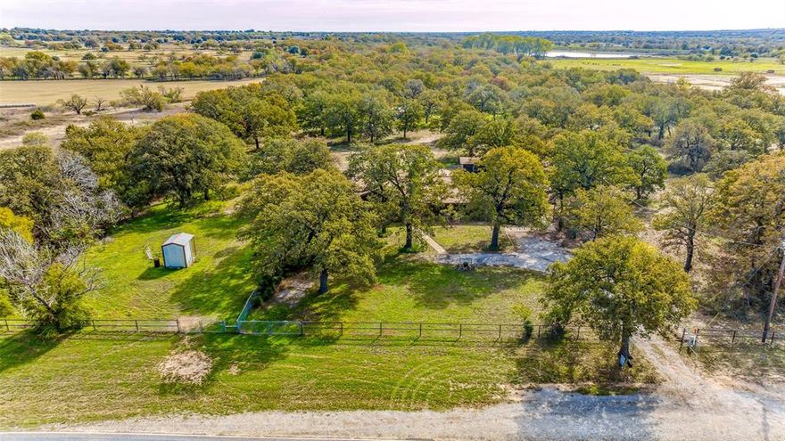 Pure country living on 27.84 acres located on a paved FM road in the highly sought after Huckabay School District. Cute & cozy ranch style w- 2,094 sqft, built in 1973 this home is primed & ready for remodel. It boasts 3 bedrooms, 2.5 bathrooms, along w- a sunroom & basement. Large living area that offers an oversized window for natural lighting & a gas log fireplace. Bursting w- character & charm, it's just waiting for your creativity & personal touch, a chance to turn your dreams into reality. The possibilities are endless! There is also seasonal pond & creek running across the rear. Mature trees provide shade & beauty, while the spacious yard beckons outdoor activities & gatherings. 2 older but functioning barns one that could be utilized for your animal & the other for storage, 2 water wells along w- fenced pastures. If you have been dreaming of a farmhouse lifestyle w- ample acreage & classic charm, don't miss the opportunity to make this property your own. Come look today!