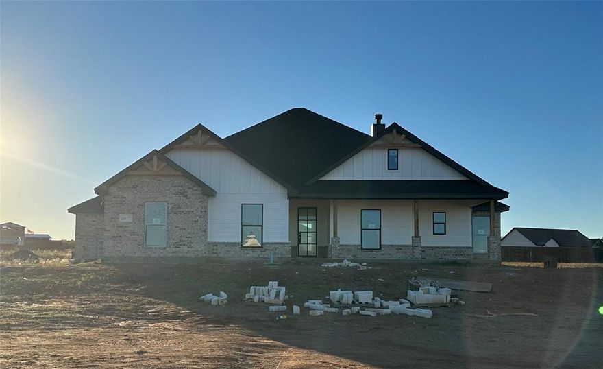 Agent related to owner.  This new Lantrip's Custom Home is located in the desirable Newhouse Farms Subdivision, outside of the city limits but just five minutes from town.  This new home offers both beauty and practicality on 0.87 acres.  Enjoy the quiet country feel in a home that offers everything needed for comfort and entertaining.  As you step through the front door, take in the sprawling wood-look vinyl flooring at your feet, the wood burning fireplace in your direct view, and the gorgeous kitchen to your left, complete with custom cabinetry, granite countertops, an island with sink, and corner pantry.  Enjoy the spa experience you will find in the ensuite, featuring a free-standing tub, separate walk-in shower, separate vanities, and oversized closet.  Enjoy your morning coffee or entertaining guests on your covered back porch.  Other notable features include a jack n jill bathroom and a third bathroom.  Builder will provide landscaping in front, and a StrucSure 2-10 Warranty.  Estimated completion- January 2026.