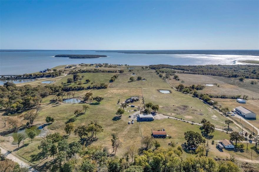 Cedar Creek Ranch presents an opportunity to purchase one of the last remaining undeveloped lakefront tracts in this area. Sitting on sixty-five rolling acres of lake front property on the north shore of Cedar Creek Reservoir lies Cedar Creek Ranch. With multiple residences, a party barn, scenic pasture acreage, and roughly 665 feet of lake frontage, this ranch is ideal for an estate style residence, weekend retreat, or future residential development. The main house measures approximately 2,690 square feet and was built in 1991 with stunning hilltop views of the lake. Sitting behind the house is a 3,600 square foot party barn built in 2015 complete with a one bedroom attached apartment. Near the gated entrance on the northern boundary of the property is a roughly 1,000 square foot guest house, next to an older hay barn with cattle pens. The majority of the property has perimeter fencing with cross fencing in place.