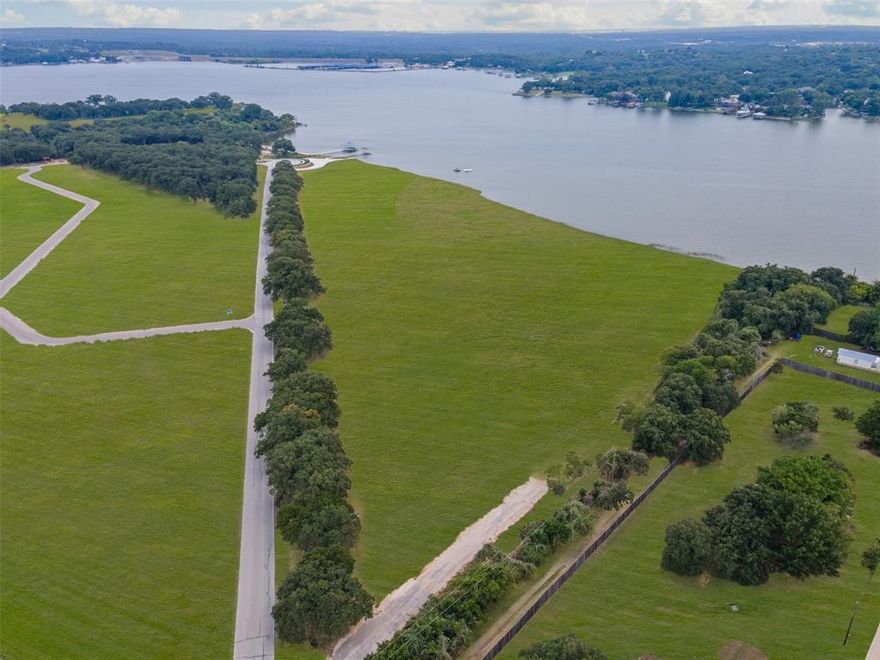 Discover Lot 2 at Waterfront on Park — a rare 1.82-acre homesite in an exclusive community on the tranquil, south-facing shores of Eagle Mountain Lake. Once a beloved city park, this private enclave now features just 16 premium lots with direct lake access for swimming, boating, and fishing, and breathtaking water views. Enjoy the serenity of lakeside living just minutes from vibrant downtown Fort Worth. This is your opportunity to create a custom retreat in a setting where nature, privacy, and convenience converge.