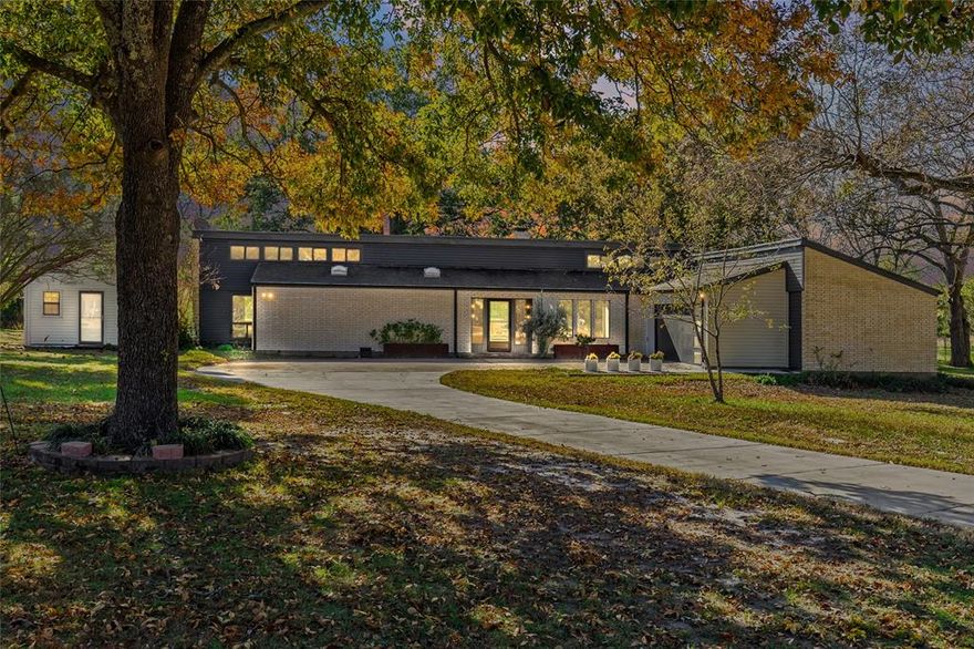 Discover this charming mid-century modern home set on nearly 1.5 acres just outside the city limits—offering the perfect blend of style, privacy, and convenience. Surrounded by large, mature trees, the property feels like a serene retreat while still being close to town. Step inside to an inviting open floor plan living area, designed with an abundance of windows that flood the space with natural light and highlight the home’s clean lines and warm mid-century character. The interior features tasteful updates throughout, including refreshed bathrooms, new flooring and modern lighting. The vaulted ceiling and brick fireplace bring charm to the living room while looking out into the private backyard. The kitchen is equipped with updated appliances and under counter lighting. All three spacious bedrooms have walk in closets and large windows, with stunning views of nature. This home also has an oversized utility room with a sink and loads of cabinet storage. Outside, the acreage provides endless possibilities. A greenhouse offers space for year-round gardening, while the workshop adds practicality for tools and other hobbies. Mature trees surround this property, truly making it one of a kind. The driveway, garage door and HVAC have all been recently replaced. The garage is oversized and also includes a storage room. This one has it ALL. A rare opportunity to own a modern-inspired home with room to breathe—this property is ready to enjoy as-is or evolve with your vision. 

A note from the seller: The minute I walked into the house I knew I was home. So much light, the view outback and the whole neighborhood. So many beautiful trees and nature.
