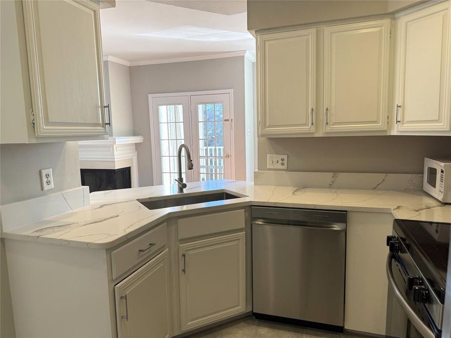 Move-in ready with two leaves 1-bedroom and 1028 sf condo. It has 1 full bath and 1 half bath in a gated community. Open floor plan with fireplace, dining area, and covered porch with additional storage. Upstairs primary suite features a flexible loft space ideal for a home office. Fully renovated interior and fresh paint throughout. Updated kitchen includes new tile, granite countertops, sink, faucet, and stainless steel appliances. refrigerator 2022 ,Wash and dryer 2023 . Renovated bathrooms feature new tile, new mirror ,fixtures, vanities, and new toilets. Additional updates include upgraded lighting, electrical panel upgrade, new blinds of windows, and new HVAC system (2023) Community amenities include gated access and pool. One assigned underground parking space. Convenient location near Addison with easy access to Dallas North Tollway, DFW Airport, and Love Field. Ideal lock-and-leave home.