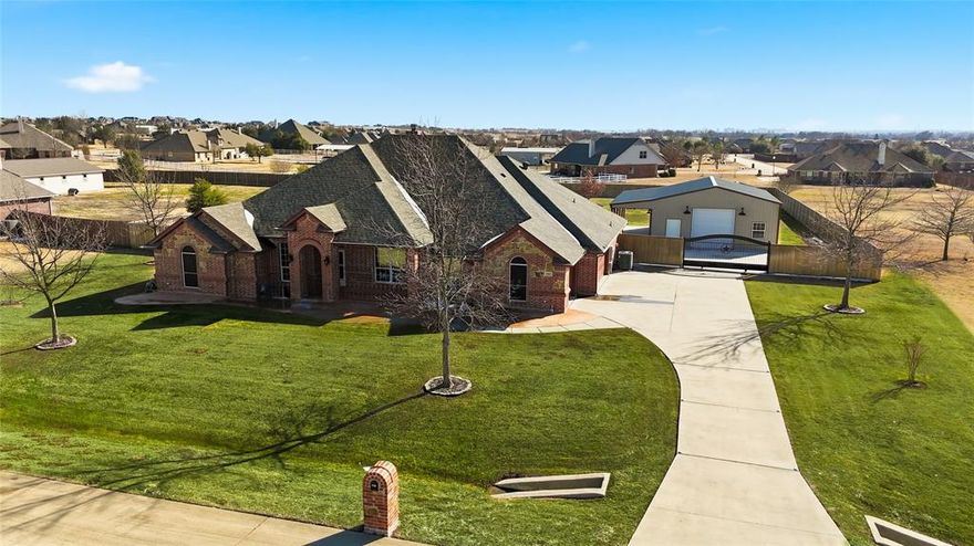 Stunning one-acre, single-story property with exceptional shop and parking features in Northwest ISD, just east of Argyle. This 4-bedroom, 2.5-bath home offers 2,818 sq ft with a split floor plan and dedicated office-flex space. The standout feature is the 20x30 insulated workshop with overhead door, abundant electrical outlets, and its own covered patio with ceiling fan—ideal for hobbies, storage, or a home-based business. An electric gate provides access to a private parking pad, complemented by an extra-deep 3-car garage perfect for trucks or additional vehicles. Inside, the spacious primary suite includes updated countertops, new walk-in shower flooring, a standalone tub, and a massive closet. Enjoy a screened-in porch with fireplace, privacy-fenced backyard, city water, and easy access to the rapidly growing Hwy 407-I-35W corridor.