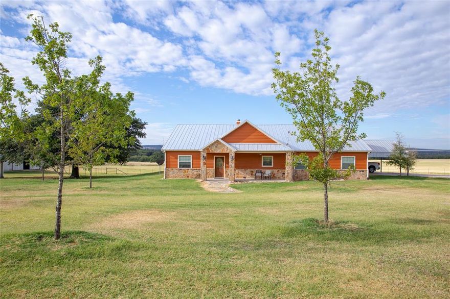 Discover the epitome of rural elegance with this majestic private custom home nestled on approximately 97 acres of pristine land. Fully fenced and cross-fenced, this property boasts high-producing coastal fields and two ponds, which attract a variety of wildlife, creating a serene and tranquil environment that is unparalleled.
Step inside this thoughtfully designed 4-bedroom, 2-bath residence, where modern comfort meets rustic charm. The open-concept layout invites natural light, accentuating the spaciousness of the living area. A wood fireplace with a propane lighter serves as a cozy focal point, seamlessly connecting to an outdoor grill for the perfect blend of indoor and outdoor entertaining. The large covered back patio offers stunning views of the coastal pastures, making it an ideal spot to unwind or host gatherings. Retreat to the spacious master bedroom, featuring direct access to the outdoor patio.  Large soaking bathtub, separate shower, dual sinks and big walk in closet. Kitchen features Gas stove, abundance of cabinets, bar, and formal dining room overlooking pastures.  Mud room at back door with sink, washer and dryer, and room for an extra freezer.  Large carport with storage room.  Barn with 5 12x12 stalls with runs.  Tack room or shop 24x16 with double doors.  Another storage shed with cover for trailers.  Huckabay ISD.  Minutes to Stephenville or the interstate.