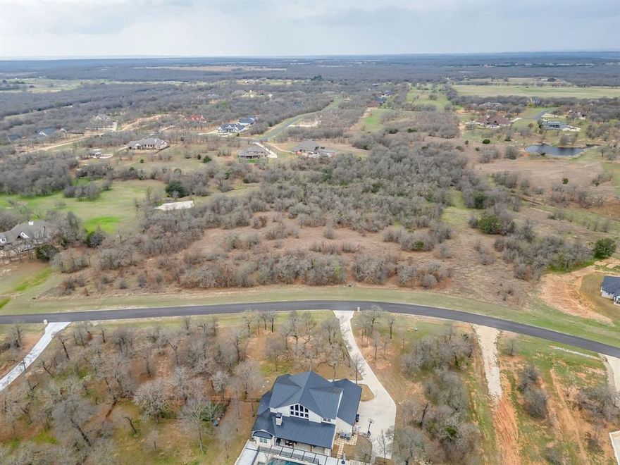 ONE-OF-A-KIND, RARE OPPORTUNITY to own 6.5 acres in The Reserve at Sugartree! This is the ONLY opportunity to own the LARGEST residential homesite in the entire community. You will have the best of both worlds with heavily-wooded private property acreage within an active neighborhood!  Build the custom home of your DREAMS here and plenty of space to put a secondary garage, guest house, shop, pool and still have an abundance of privacy! Replat costs have already been paid and the water tap is paid and installed. Sugartree is known for the social atmosphere and amenities to enjoy! Not only are there amenities such as the community pool & amenity center, fitness room, and sand volleyball court, but the Sugartree Golf Club has an on-site cafe called The Eatery. It is open daily for residents, members and outside guests! They have happy hours, Friday Night dinner specials and events regularly! The golf course has had a tremendous amount of improvements on the greens, fairways and overall play experience, making it one of the most desirable in the area! The POA puts on several social events during the year such as Karaoke Night, Sugartree Night out with catered dinner and live band, family-friendly events during Christmas, Easter and Fall Festival, Fourth of July parades, pool bashes, community garage sales, you name it! Residents enjoy fishing, golfing, golf cart ride, and community get-togethers of all ages. Come join the fun!