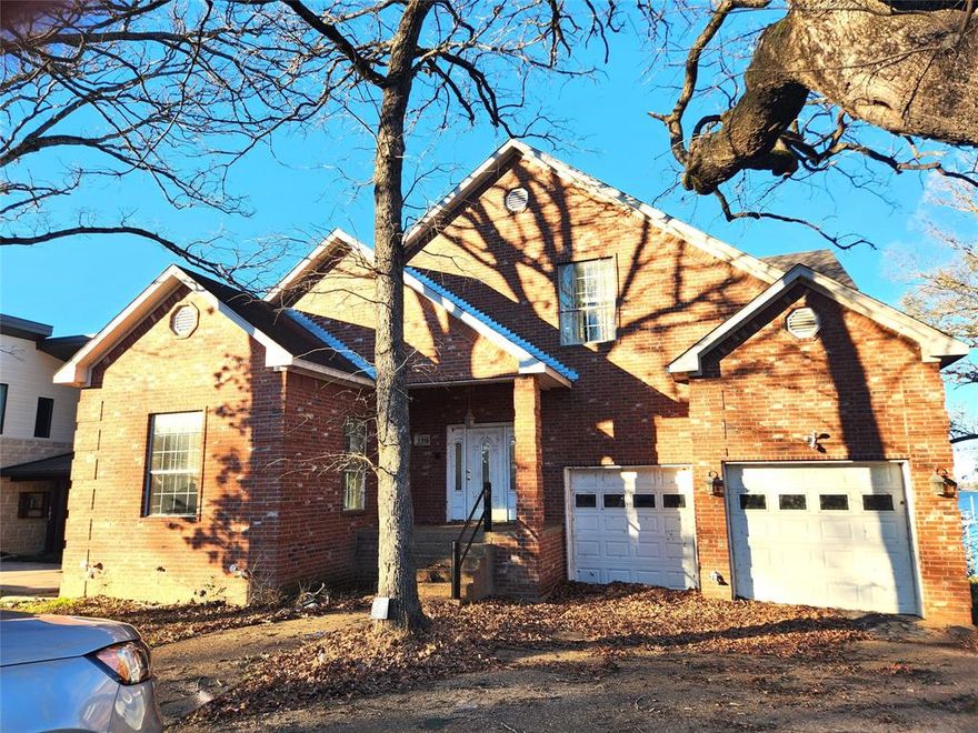 Large home with so much potential. Home has a full apartment downstairs that opens out onto the open water. This creates so many opportunities for shared family residence or income potential. The main floor has primary suite, kitchen, formal living, dining, office and den with fireplace that opens onto balcony overlooking the water. Upstairs is a bedroom, living area and huge bath with soaking tub, double sinks, shower, and walk in closet. This home could be a show place. Beautiful view of Cedar Creek Lake, steel retaining wall, garage and established yard. This is a quiet, well-maintained neighborhood. Located just an hour from Dallas, Tx.