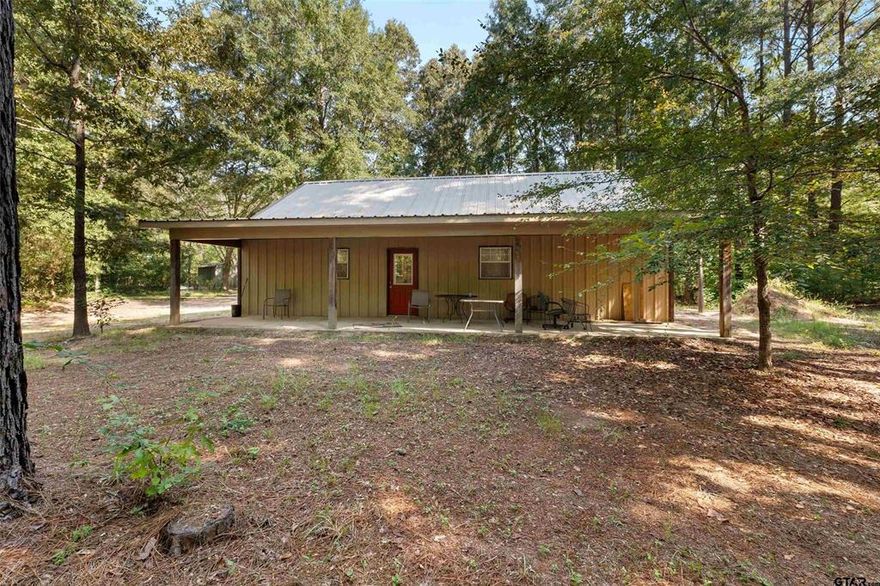 **MOTIVATED SELLER** Escape to the perfect blend of rural tranquility and modern living with this beautiful 2 bedroom, 2 bath barndominium nestled on 4 private, wooded acres just north of Jacksonville, TX. Built in 2017, this custom home offer slow maintenance finished concrete floors throughout and exceptional energy efficiency thanks to full spray foam insulation. Step inside to an open concept living area filled with natural light, seamlessly flowing into the spacious kitchen featuring custom cabinetry, a large pantry, gas range cooktop and oven, and convenient bar seating — ideal for entertaining or casual family meals. Each of the two generously sized bedrooms includes a full ensuite bathroom, complete with tub shower combos and roomy vanities, as well as ample closet space. A dedicated utility room makes laundry a breeze, and a fully decked upstairs loft, accessed via a dedicated staircase, provides excellent storage space that stays comfortable year round due to the insulation. Enjoy peaceful mornings or evenings on either of the two large porches, the back porch even includes an enclosure with large windows for bug free relaxation while taking in the serene views of your wooded property. Watch deer wander through your land, or explore the natural trails winding through the trees, this property is a dream for outdoor lovers. Bonus features include a dedicated work shed and a conex container workshop equipped with electricity, ideal for hobbies, extra storage, or a functional workspace. Fiber optic internet available! If you're looking for a secluded retreat with modern amenities and room to roam, this unique property has it all. Come experience the charm and possibilities for yourself!