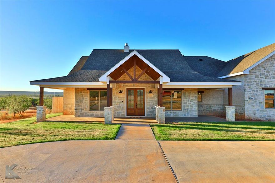 Exquisitely designed  modern farmhouse is situated on a sprawling 1.5 acre VIEW lot in south Abilene. Circular driveway, hill country style stone & brick façade with wood beams plus welcoming porch ushers guests in! Open concept floorplan with soaring vaulted ceilings is ideal for hosting & includes stone fireplace, French doors & natural light galore. Chef's kitchen designed with wine storage, farm sink, gas range, wall oven, walk-in pantry & breakfast bar for casual dining. Spacious dining finishes out the space. Split design offers master privacy & spa like en suite with oversized walk-in shower & relaxation tub. Closet is conveniently situated with entrance straight into the laundry room for wash with ease. Secondary rooms have ample space & share well appointed full bath. Private office could function as 5th bedroom. 2nd story bonus could be finished to provide an additional 525+ sq feet. Patio offers panoramic views & a spot to cookout with friends plus overlooks huge backyard.