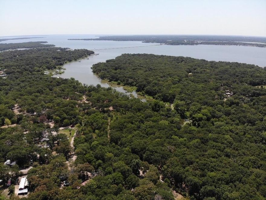 Beautiful lot with large hardwoods backing up to lake Tawakoni. Easy access to lake Tawakoni from back of property. No neighbors to rear of property make this the perfect get away, lake home or air bnb spot. No known restrictions and mobile homes allowed. Selling 5 lots total and will sell together.